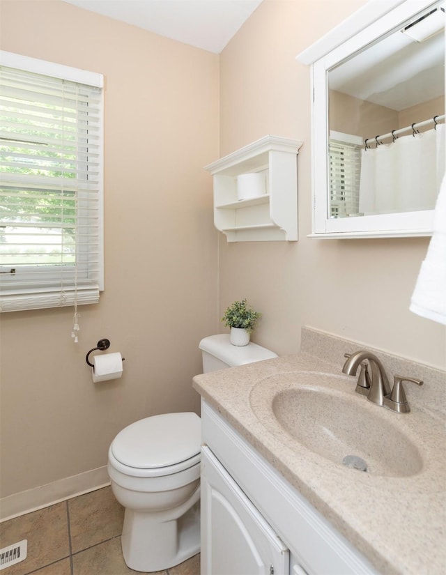 bathroom with toilet, vanity, tile patterned flooring, baseboards, and a shower with curtain
