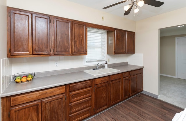 kitchen with a sink, a ceiling fan, tasteful backsplash, and light countertops