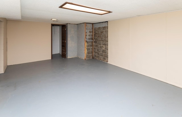 finished basement featuring concrete block wall
