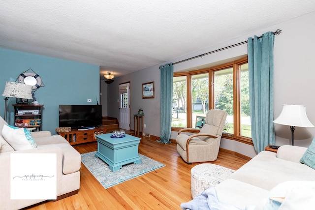 6404 Meredith Dr, Urbandale, IA 50322 - living area featuring wood finished floors, a textured ceiling, and baseboards