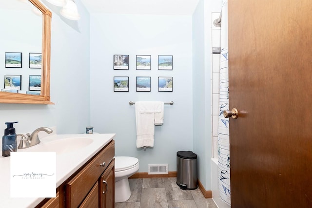 6404 Meredith Dr, Urbandale, IA 50322 - full bathroom with toilet, vanity, and baseboards