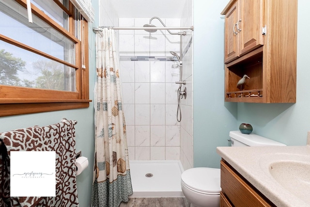 6404 Meredith Dr, Urbandale, IA 50322 - bathroom with a stall shower, toilet, and vanity