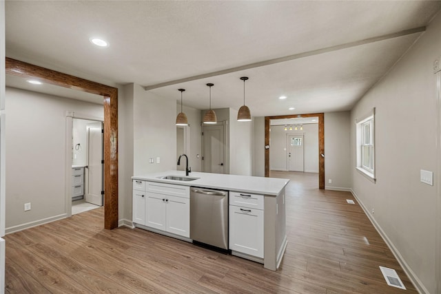 504 9th St, West Des Moines, IA 50265 - kitchen with a sink, stainless steel dishwasher, white cabinets, recessed lighting, and light wood finished floors