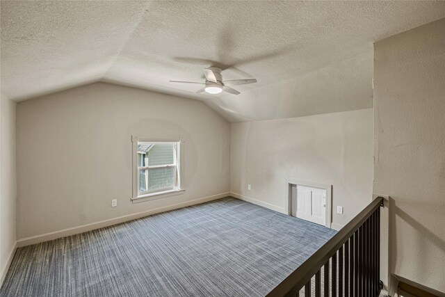 504 9th St, West Des Moines, IA 50265 - bonus room with lofted ceiling, ceiling fan, carpet, a textured ceiling, and baseboards