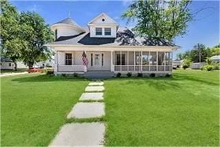 view of front of home with a front yard and a porch