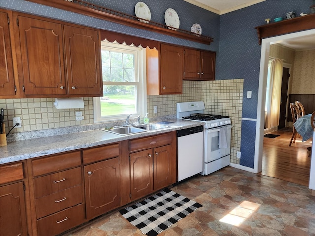 903 Greene St, Adel, IA 50003 - kitchen featuring white appliances, wallpapered walls, light countertops, a sink, and brown cabinetry