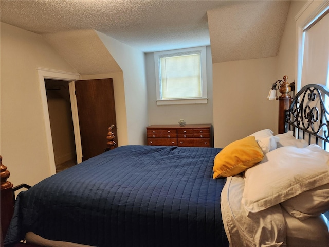903 Greene St, Adel, IA 50003 - bedroom with a textured ceiling and lofted ceiling