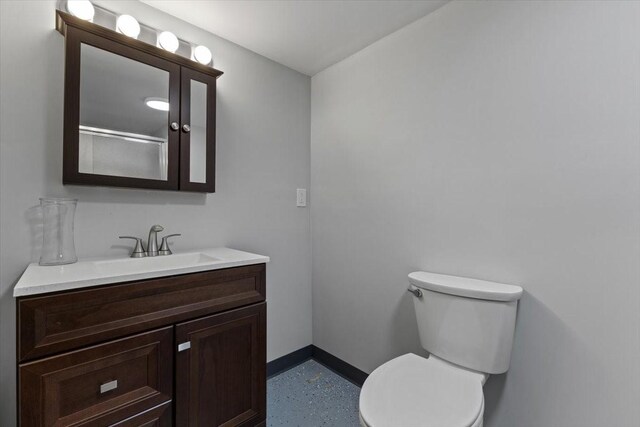 515 Kingman Blvd, Madrid, IA 50156 - bathroom with baseboards, vanity, and toilet