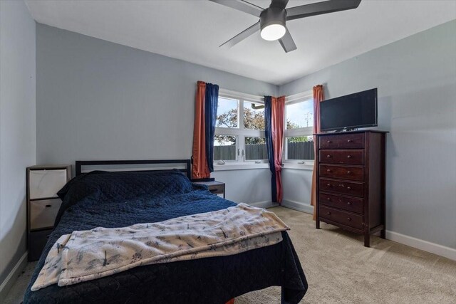 515 Kingman Blvd, Madrid, IA 50156 - bedroom featuring baseboards, light colored carpet, and ceiling fan