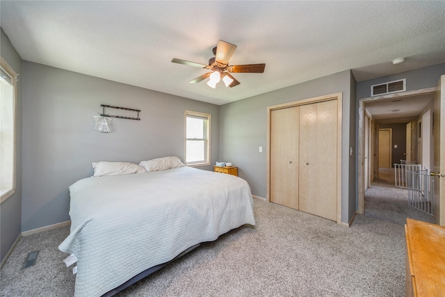 612 W Pleasant St, Pleasantville, IA 50225 - bedroom with a closet, carpet floors, a ceiling fan, and baseboards