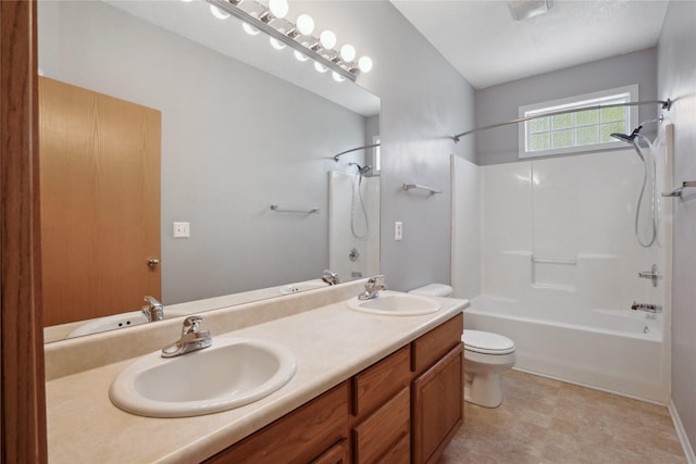 bathroom featuring toilet, shower / bathtub combination, and double vanity
