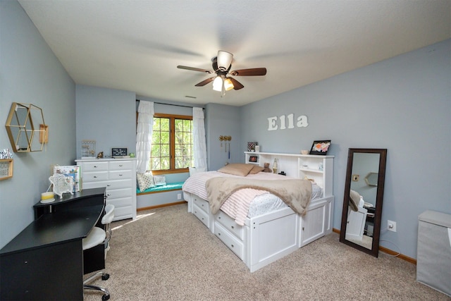 bedroom featuring a desk, carpet floors, a ceiling fan, and baseboards