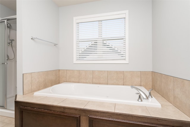 full bath featuring a shower stall and a garden tub