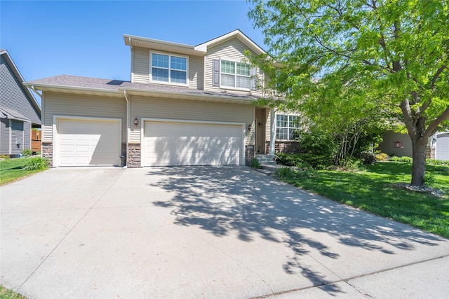 view of front of house featuring concrete driveway, stone siding, a front yard, and a garage