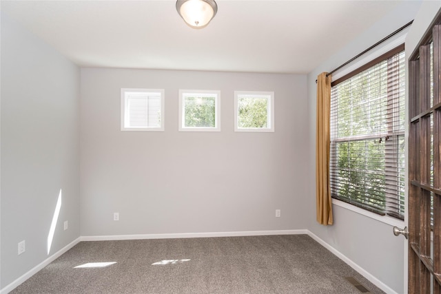 spare room with carpet flooring and baseboards