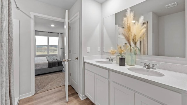 1415 Northview Dr, Waukee, IA 50263 - ensuite bathroom featuring wood finished floors and double vanity