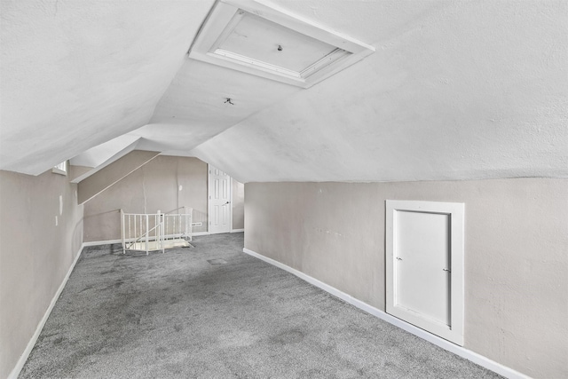 1360 E 9th St, Des Moines, IA 50316 - bonus room with lofted ceiling, carpet floors, and attic access