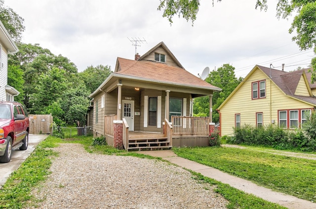 1360 E 9th St, Des Moines, IA 50316 - view of front facade with a porch, a chimney, driveway, and a shingled roof