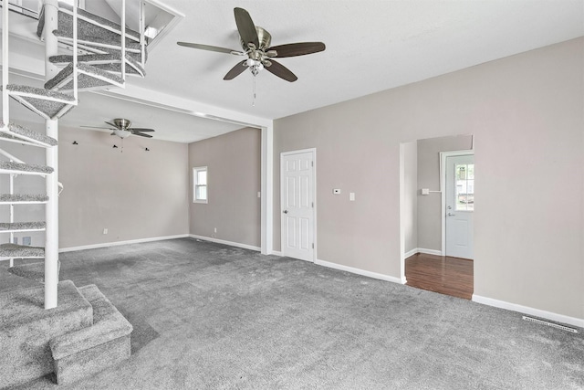 1360 E 9th St, Des Moines, IA 50316 - unfurnished living room with a ceiling fan, carpet floors, and healthy amount of natural light