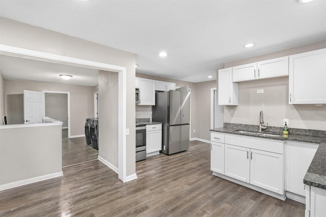 1360 E 9th St, Des Moines, IA 50316 - kitchen with appliances with stainless steel finishes, washing machine and clothes dryer, white cabinetry, and recessed lighting