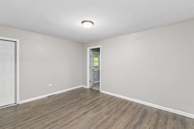 1360 E 9th St, Des Moines, IA 50316 - unfurnished room featuring wood finished floors and a textured ceiling