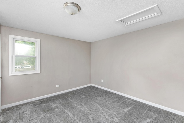 1360 E 9th St, Des Moines, IA 50316 - unfurnished room with attic access, a textured ceiling, and dark carpet