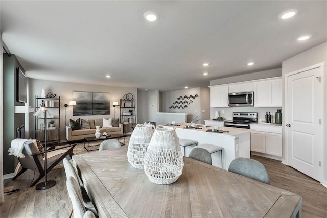 dining room with wood finished floors and recessed lighting