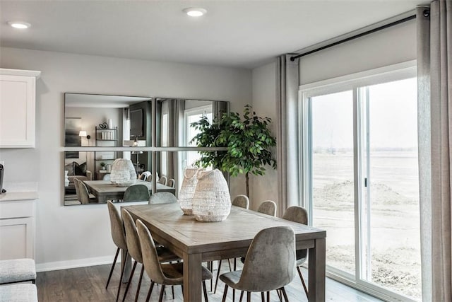 dining area featuring dark wood finished floors, baseboards, and recessed lighting