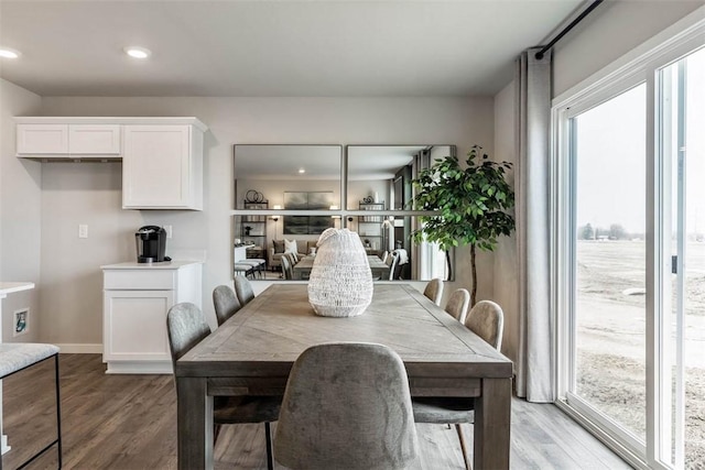 dining space with light wood finished floors, recessed lighting, and baseboards