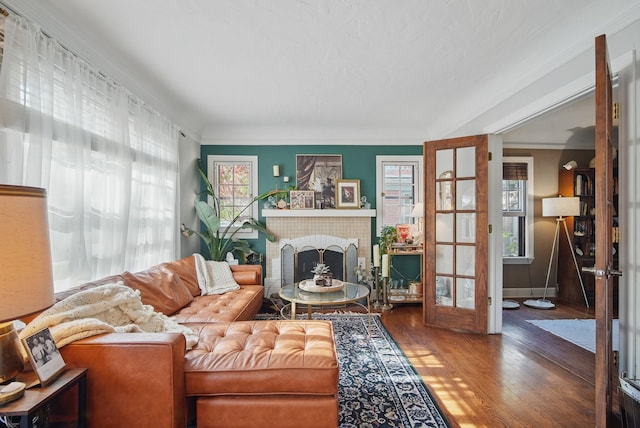 1534 41st St, Des Moines, IA 50311 - living area with wood finished floors, a brick fireplace, and ornamental molding