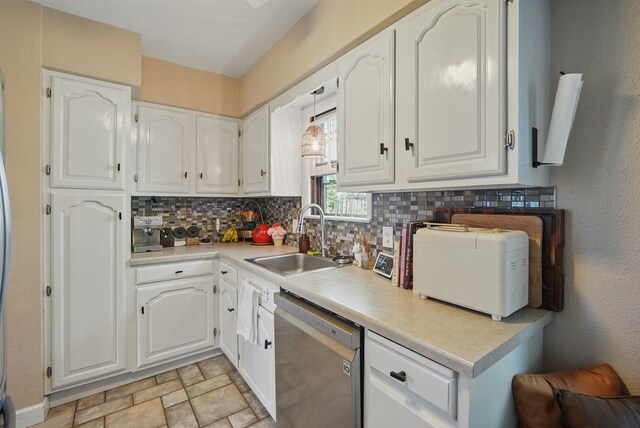 1534 41st St, Des Moines, IA 50311 - kitchen with dishwasher, a sink, decorative backsplash, and white cabinetry