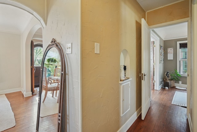 1534 41st St, Des Moines, IA 50311 - corridor with wood-type flooring, crown molding, arched walkways, baseboards, and a textured wall