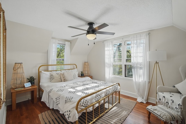 1534 41st St, Des Moines, IA 50311 - bedroom with wood finished floors, lofted ceiling, ceiling fan, a textured ceiling, and baseboards