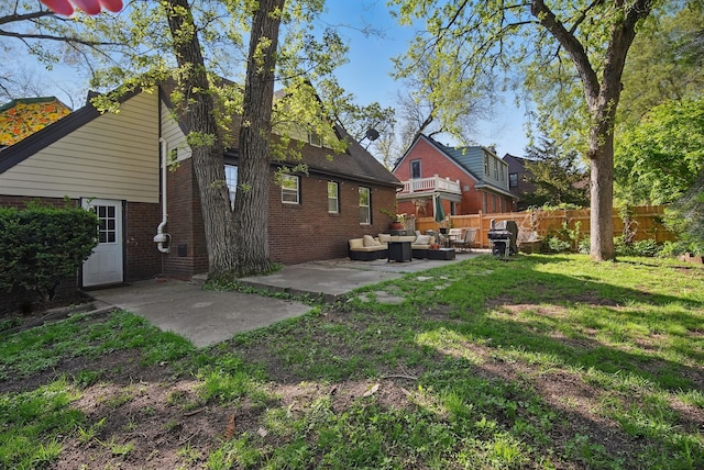1534 41st St, Des Moines, IA 50311 - rear view of property featuring an outdoor hangout area, a patio area, and brick siding