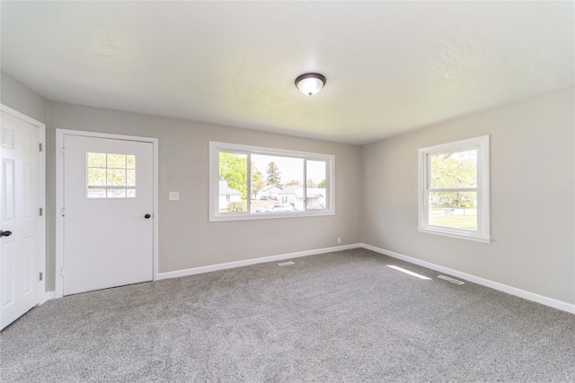 408 E Benton St, Winterset, IA 50273 - empty room with carpet flooring and baseboards