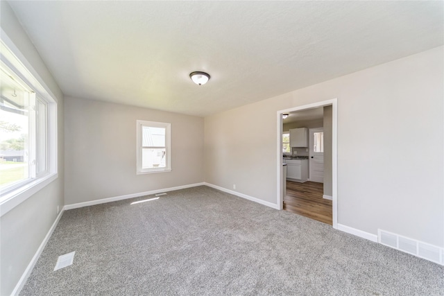 408 E Benton St, Winterset, IA 50273 - carpeted spare room featuring baseboards