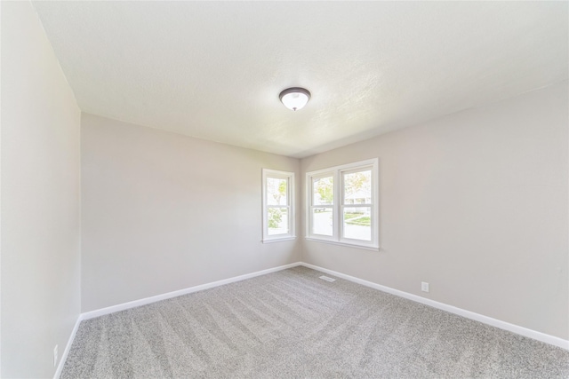 408 E Benton St, Winterset, IA 50273 - spare room featuring carpet and baseboards