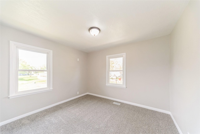 408 E Benton St, Winterset, IA 50273 - carpeted empty room with baseboards