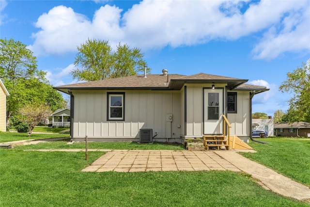 408 E Benton St, Winterset, IA 50273 - rear view of house with entry steps, a lawn, and board and batten siding
