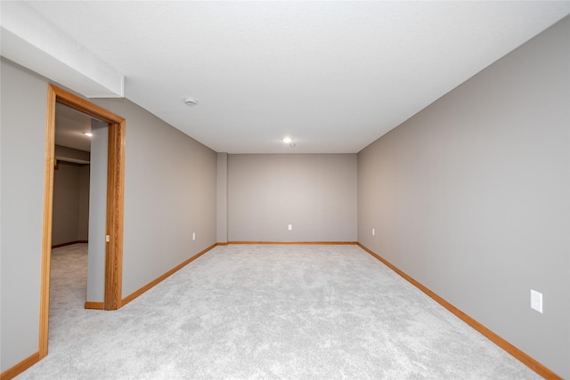 spare room with carpet and baseboards
