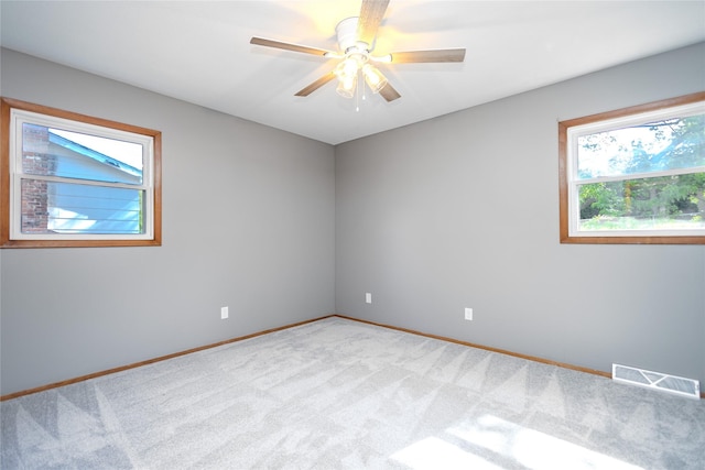 unfurnished room with a ceiling fan, carpet floors, and baseboards