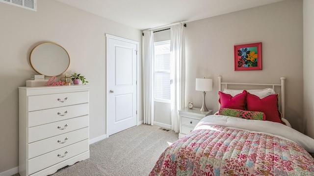 bedroom featuring light carpet and baseboards