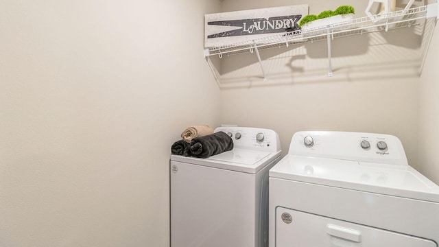 clothes washing area featuring separate washer and dryer