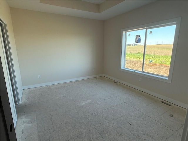 spare room featuring baseboards