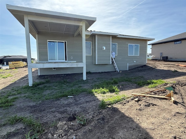 back of house with central air condition unit