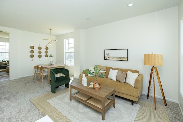 213 Bridgewood Dr, West Des Moines, IA 50266 - living area with light carpet, arched walkways, a chandelier, and recessed lighting