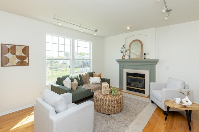 213 Bridgewood Dr, West Des Moines, IA 50266 - living room featuring track lighting, wood finished floors, and a tiled fireplace