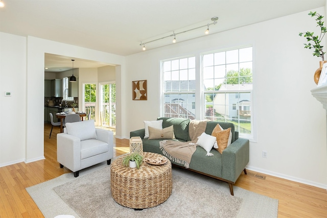 213 Bridgewood Dr, West Des Moines, IA 50266 - living room featuring wood finished floors and track lighting