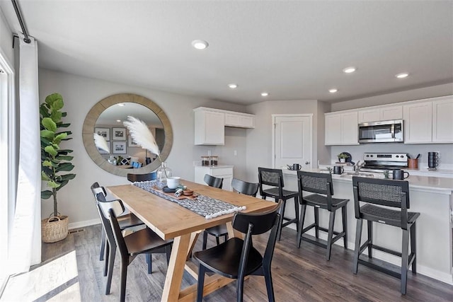 dining space with recessed lighting, dark wood finished floors, and baseboards