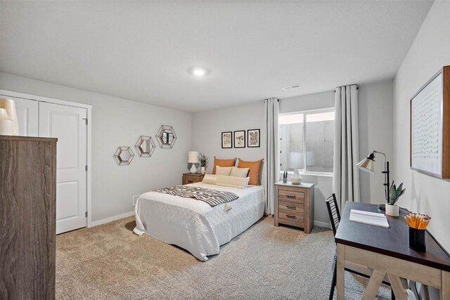 bedroom with light colored carpet, baseboards, and recessed lighting